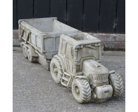 A reconstituted stone model of a tractor and trailer, 124cm long overall