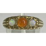 9CT GOLD RING set with central orange garnet, flanked by opals, size P, 5.7gms Provenance: private