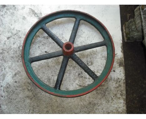A cast iron six spoke steam engine wheel, 59.5cm diameter.