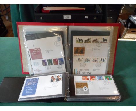 A collection of first day covers and stamps contained within albums.