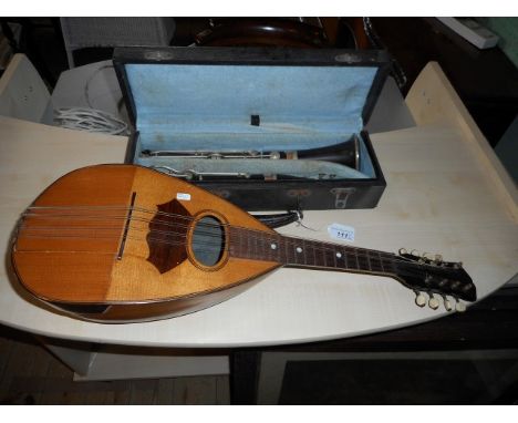 A cased French clarinet, together with an eight string mandolin, 60cm.