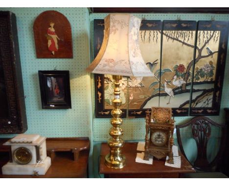 A brass table lamp, having a graduated bobbin turned type column and hexagonal cloth shade.