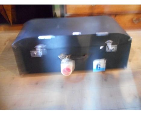 A black canvas covered vintage car trunk, with chrome locks and leather carry handle.