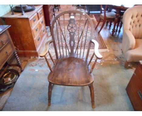 A reproduction wheel and stick back Windsor armchair.