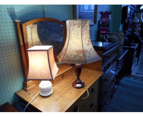 A turned wood table lamp and shade, together with a white ceramic table lamp and shade.