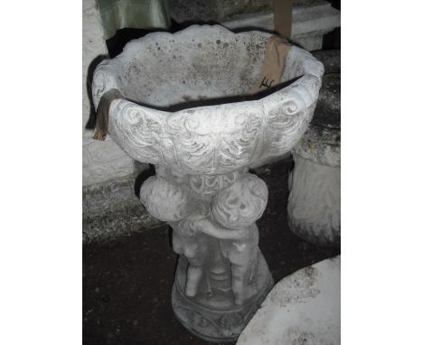 A reconstituted stone garden planter, the dished top supported by a figural column on circular foot, 53cm.