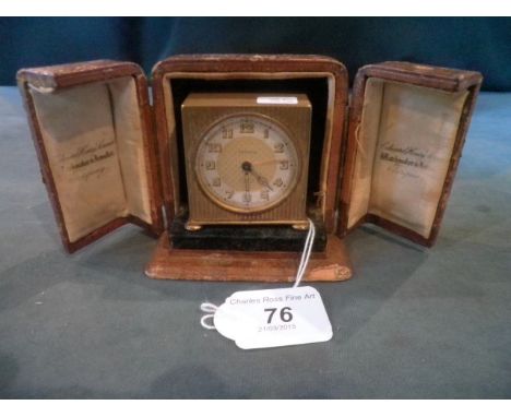 A circa 1930's Zenith brass cased travelling alarm clock in leather outer case, 5.5cm.