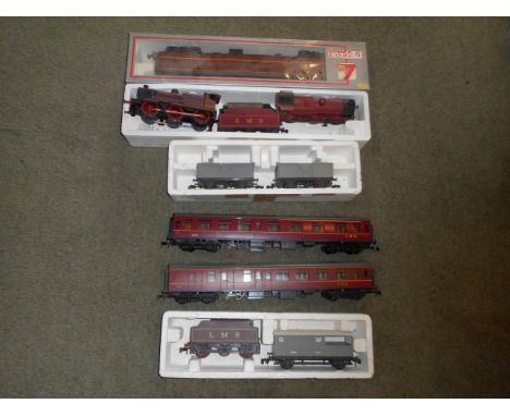 A boxed Lima 'o' gauge locomotive and tender, together with another locomotive, passenger wagons and other rolling stock.