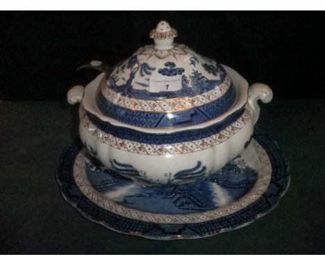 A Booths Real Old Willow soup tureen and cover, no. A8025, together with an associated oval stand and a silver plated ladle.