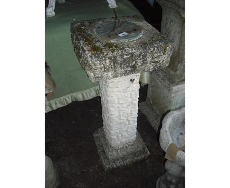 A reconstituted stone sundial, having a cast metal gnomon on a square top, brick effect column and stepped square plinth, 85c