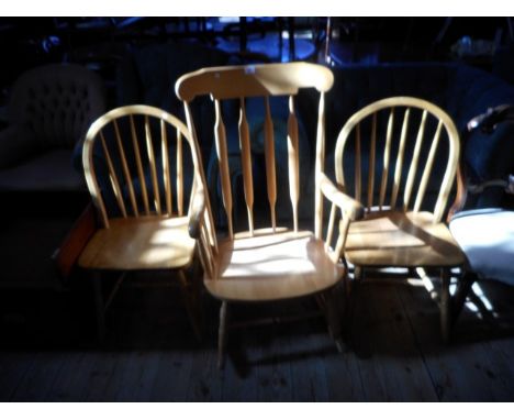 A contemporary beech lathe back rocking chair, together with a pair of hoop and stick back kitchen dining chairs.