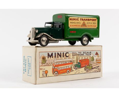 A Tri-ang Minic delivery van with cark green cab and lighter box back, Decals applied to the side for " MINIC TRANSPORT" Road