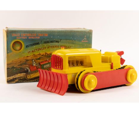 A 1960s plastic battery operated SPACE CONTROLLED TRACTOR. Astounding, Fascinating, it actually steers itself. Made in the Br