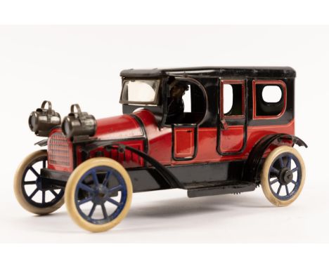 A rare German tinplate clockwork Limousine by K.B.N. BAVARIA (Karl Bub Nurenberg). Finished in a deep red and gloss black, wi