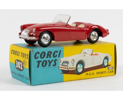 Corgi Toys M.G.A. Sports car (302). A late example in bright red with cream interior and dished spun wheels. Boxed, with pape