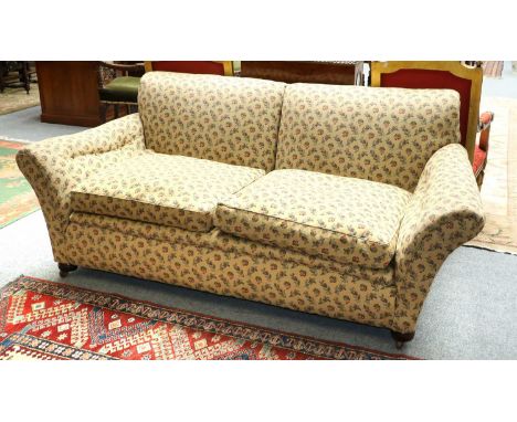 A Two-Seater Sofa, with outscrolled arms and mahogany legs, with fruit and floral fabric, 210cm by 98cm by 86cm