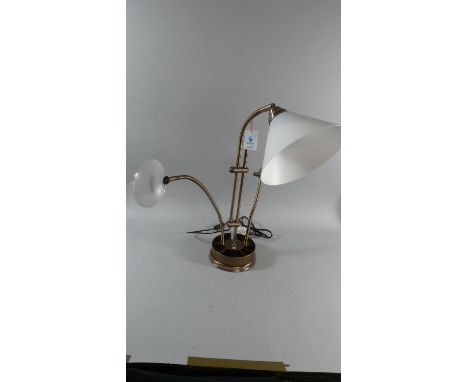 A Modern Adjustable Working Lamp with Magnifying Glass and Bull Dog Clip on Circular Weighted Base 