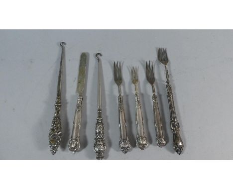 A Collection of Silver Handled Items to Include Forks, Button Hooks and a Butter Knife 