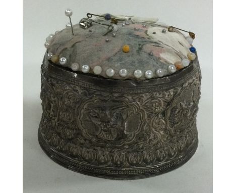 A large heavy Indian silver pin cushion. Approx. 344 grams of gross weight. Est. £100 - £150.