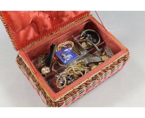 A VINTAGE SEWING BASKET CONTAINING COSTUME JEWELLERY