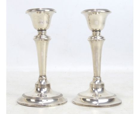 S BLANCKENSEE &amp; SON LTD; a pair of Edward VII hallmarked silver candlestick with bell shaped sconces, on tapering stems a