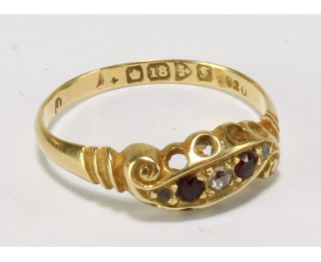 An Edwardian 18ct yellow gold, diamond and ruby dress ring, with five melee stones in foliate scroll setting, size O, approx 