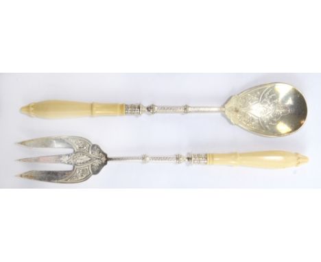 WILLIAM HUTTON &amp; SONS LTD; a pair of Victorian hallmarked silver marine ivory handled salad servers with engraved foliate