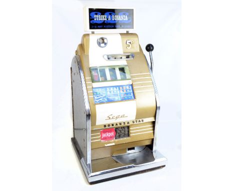 A circa 1960s Sega Bonanza Star 'Strike A Bonanza' one arm bandit slot machine, takes old 5p coins, in cream and gold with ch