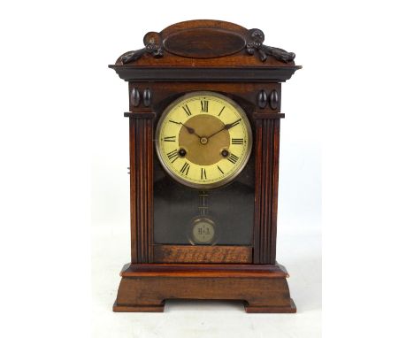 An early 20th century American mantel clock, the circular dial set with Roman numerals, height 38cm.