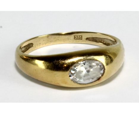 A yellow metal dress ring set with a non precious white stone, stamped '375' to band interior, size K, approx 1.4g.&nbsp;