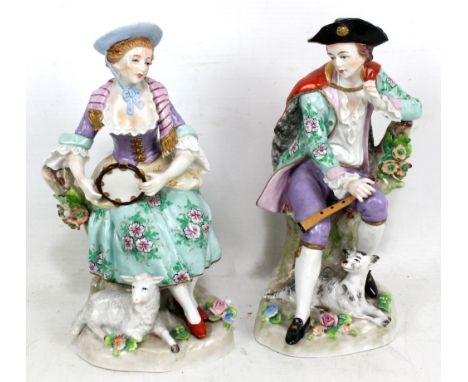 SITZENDORF; a&nbsp;pair of porcelain figures, lady holding tambourine with seated lamb and gentleman holding flute with dog, 