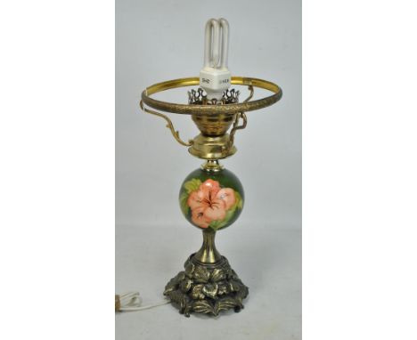 MOORCROFT; an early 20th century 'Hibiscus' pattern tubeline decorated oil lamp, now converted to a electrical, with bulbous 