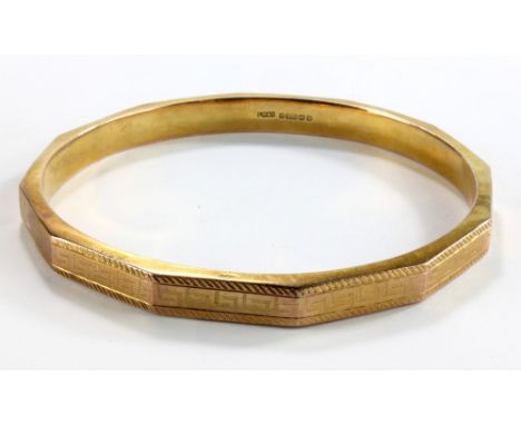 A 9ct yellow gold hollow faceted bangle engraved with Greek key, internal diameter 8cm, approx 16.1g.Additional InformationTh