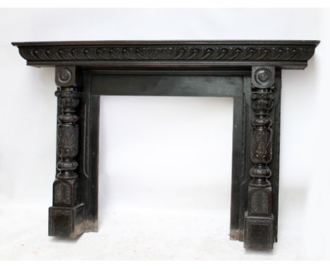 A large Victorian oak fire surround with gadrooned mantel above elaborately carved and turned jambs, width 200cm.