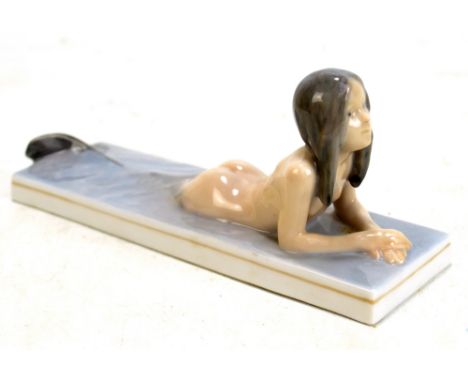 ROYAL COPENHAGEN; a figure modelled as a mermaid, painted and printed marks to base, length 20cm.Additional InformationSome m