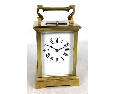 A brass cased repeating carriage clock, the circular dial set with Arabic numerals, numbered 62992 to reverse, height excludi