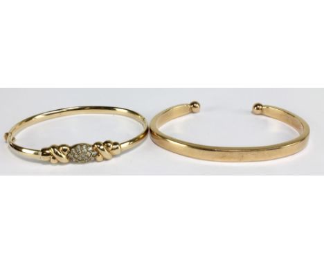 A 9ct yellow gold snap bangle with cubic zirconia navette shaped platform flanked by knots, aperture 6.5 x 5.5cm, and a 9ct g