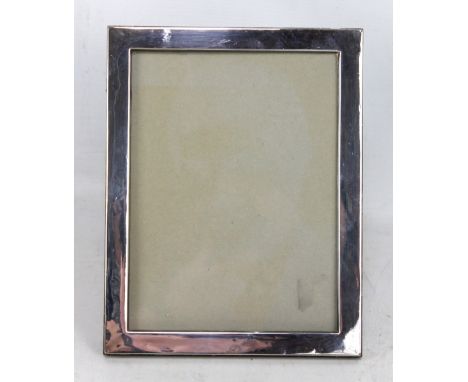 J &amp; R GRIFFIN LTD; a George V hallmarked silver rectangular photo frame of plain form, Chester 1914, 24 x 18.5cm (back af