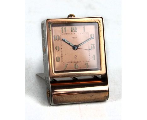 JAEGER; an early to mid-20th century Swiss travel alarm clock in hinged metal case, the square dial set with Arabic numerals,