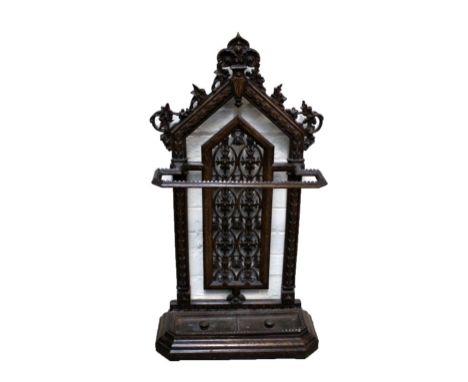 A Victorian cast iron stick stand with pierced arched back and shaped drip tray.