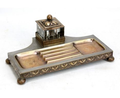 An early 20th century Jungenstil type inkstandish with glass well (af) above dished section for pens and with stylised Art No