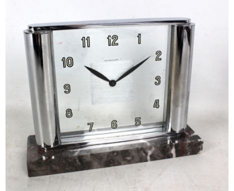 JAEGER LECOULTRE; an Art Deco mantel clock with chromed frame enclosing square clear glass dial set with Arabic numerals on r