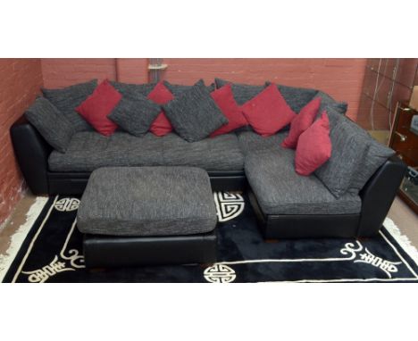 SEDUTA D'ARTE; a black leather corner sofa and a pouffe with canvas cushions.&nbsp;