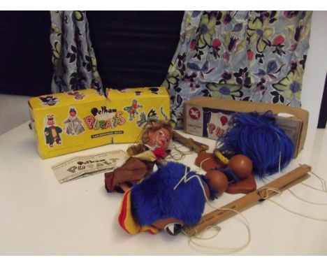 Two vintage Pelham puppets with boxes together with a stage theatre 