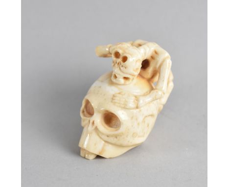 An Oriental Carved Bone Netsuke in the Form of Skeleton and Skull, Signed to Base, 5cms High 