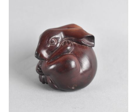 An Oriental Carved Wooden Netsuke in the Form of a Long Eared Rabbit 