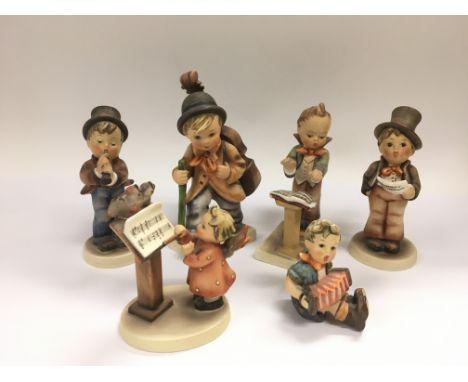 Six Goebel Hummel figures of children.