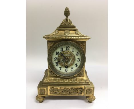 A gilt cased mantle clock with enamel dial, approx height 26.5cm.