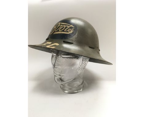 A WW2 British home front fire guard Zuckerman helmet painted with the Boots the chemist logo.