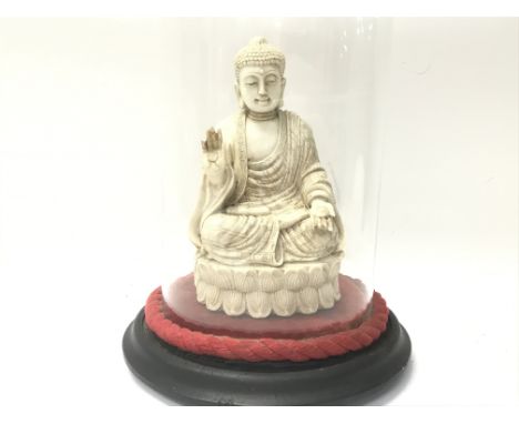 A good old vintage figure of a Buddha under a glass dome